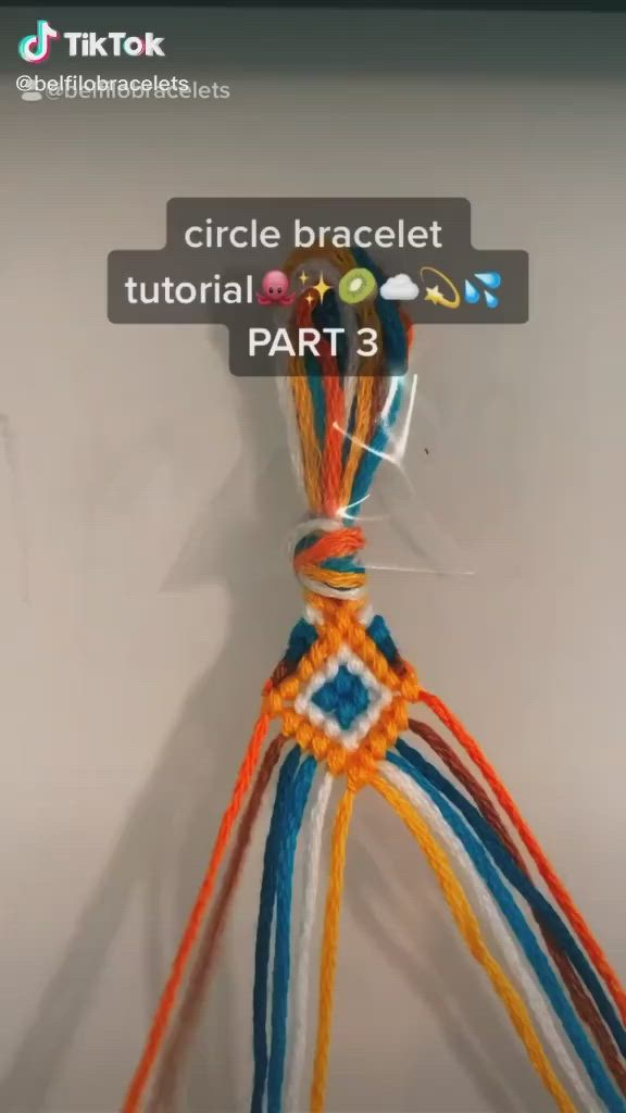 This may contain: an orange, white and blue rope is attached to a wall with the words circle bracelets part 3 on it