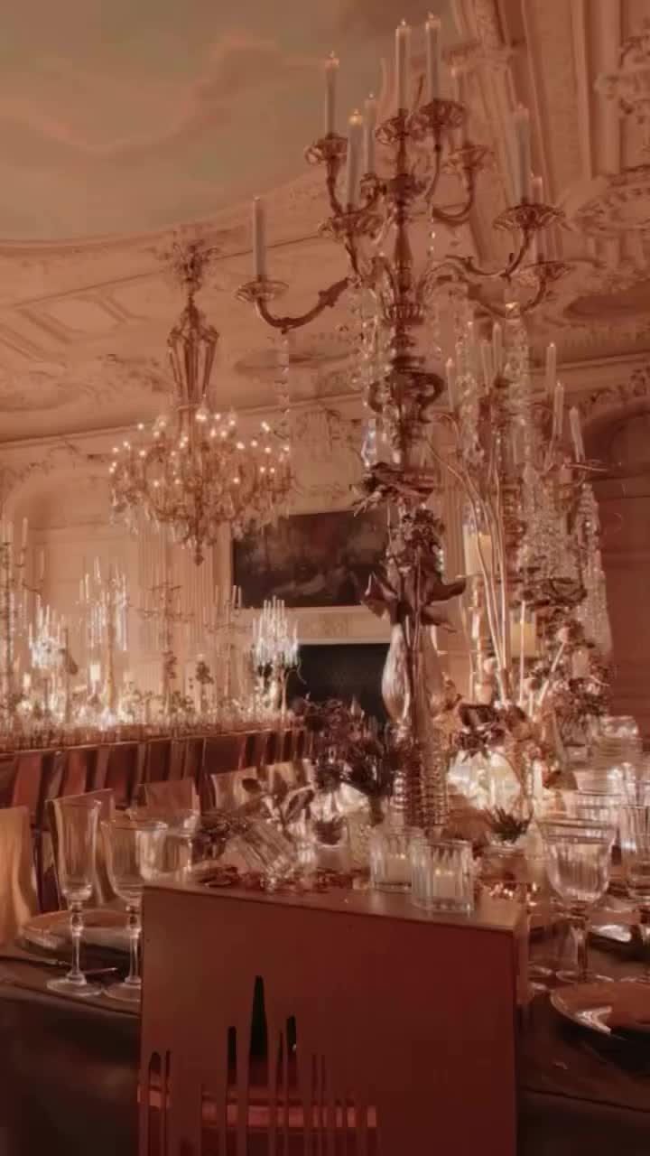 This may contain: a chandelier hanging from the ceiling in a room