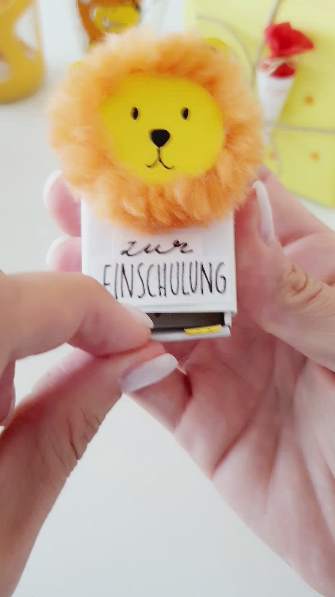 This may contain: a person holding a small toy with a lion on it