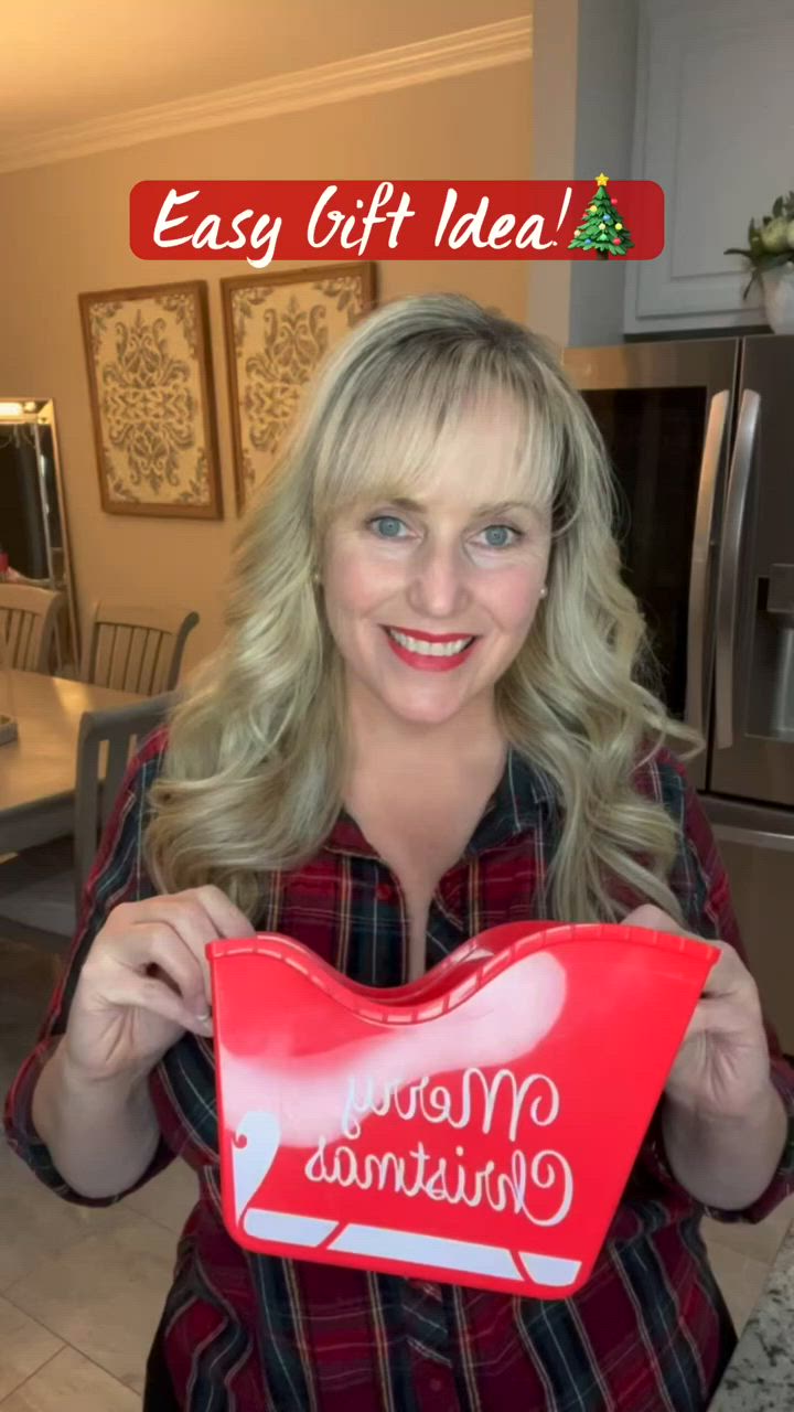 This may contain: a woman holding up a red heart shaped box with the words easy gift idea on it