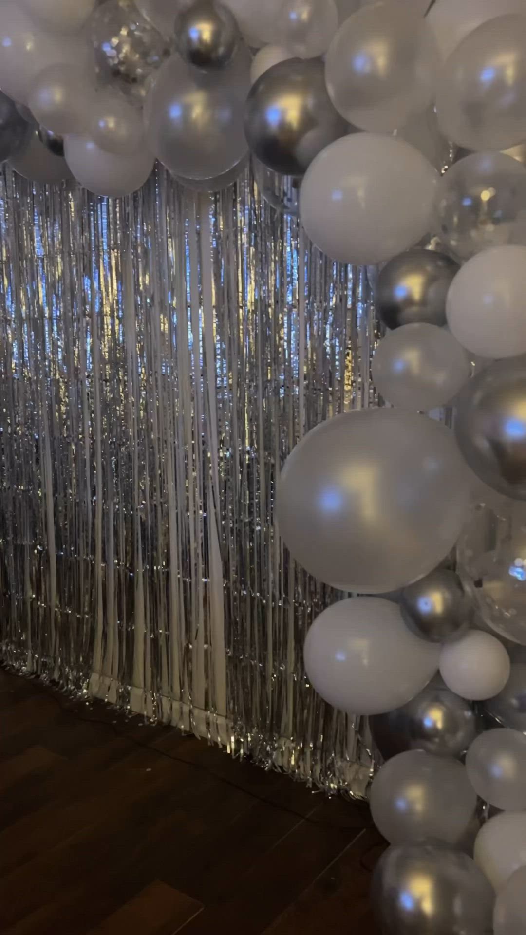 This may contain: a table with balloons and a sign that says new year's eve