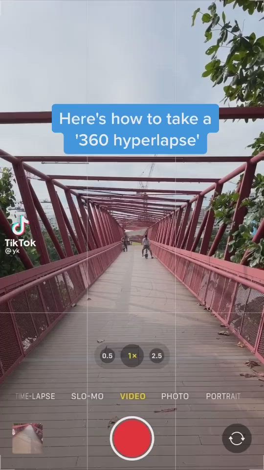 This may contain: an image of a red bridge with people walking on it and the text here's how to take a 360 hyppherflipe