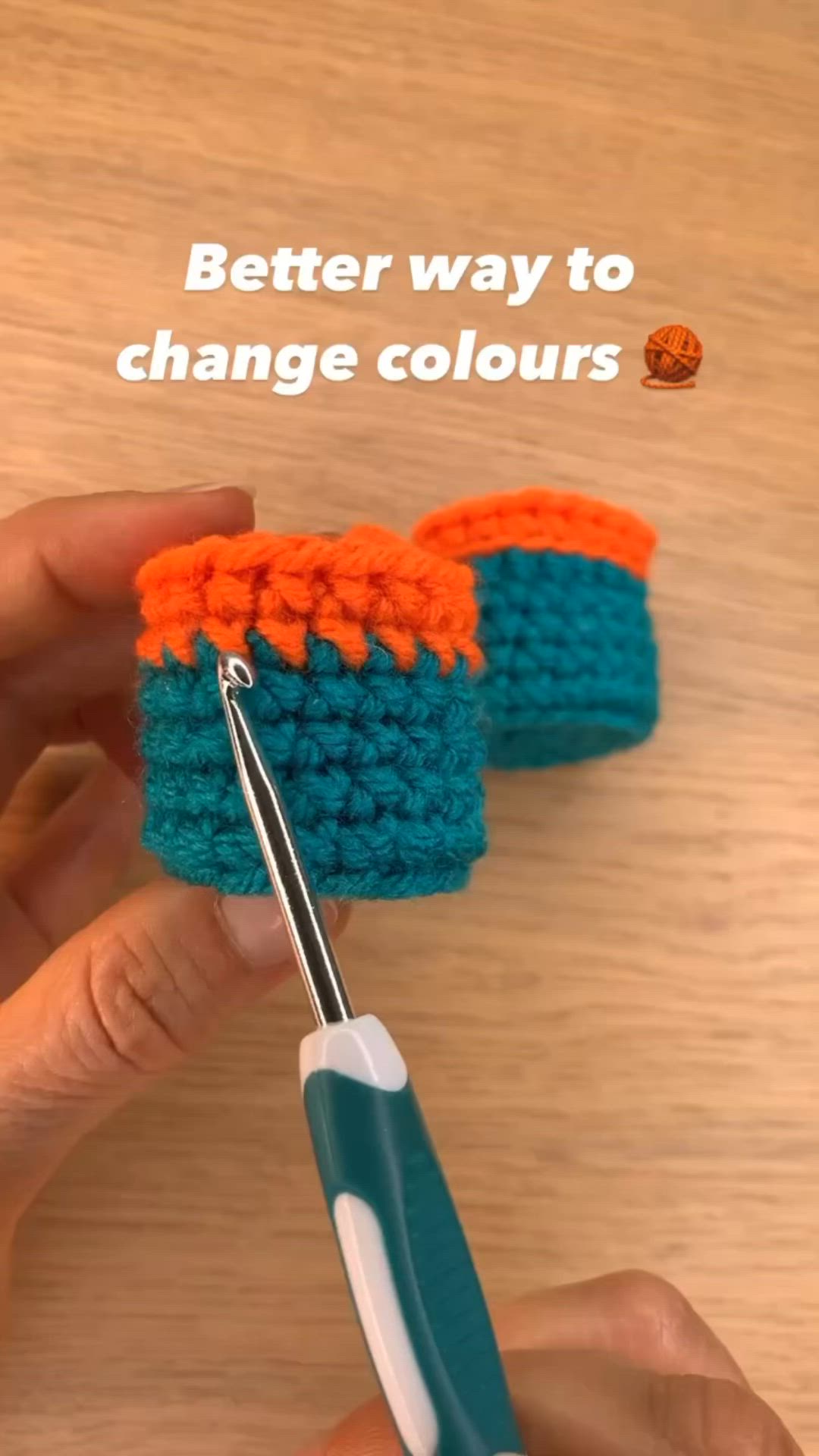 This may contain: someone is crocheting something with scissors on the table and text reads, better way to change colours