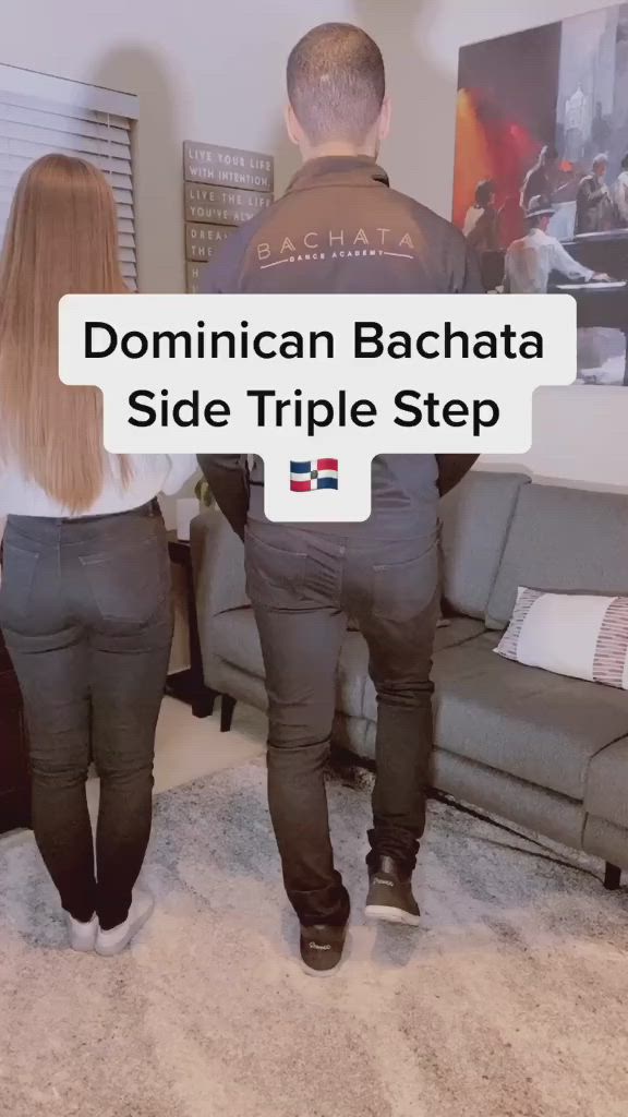 This may contain: two people standing in front of a couch with the caption'dominican bachata side triple step '