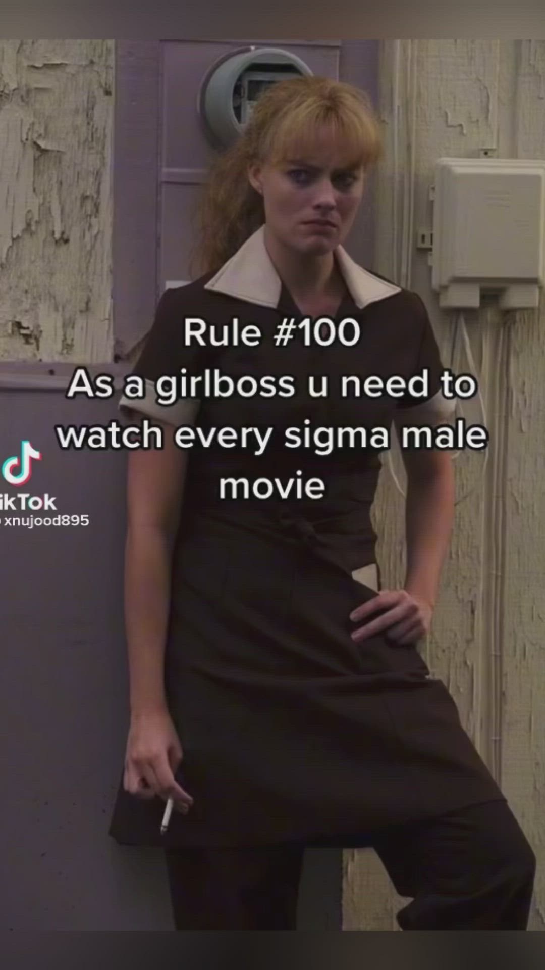 This may contain: a woman leaning against a wall with the caption'rules 100 as a girlbos u need to watch every stigma male movie '