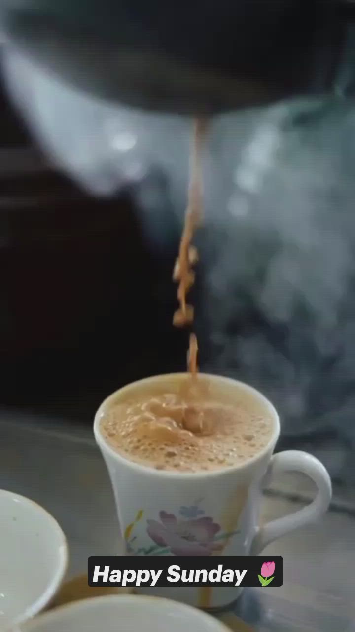 This may contain: coffee being poured into a white cup