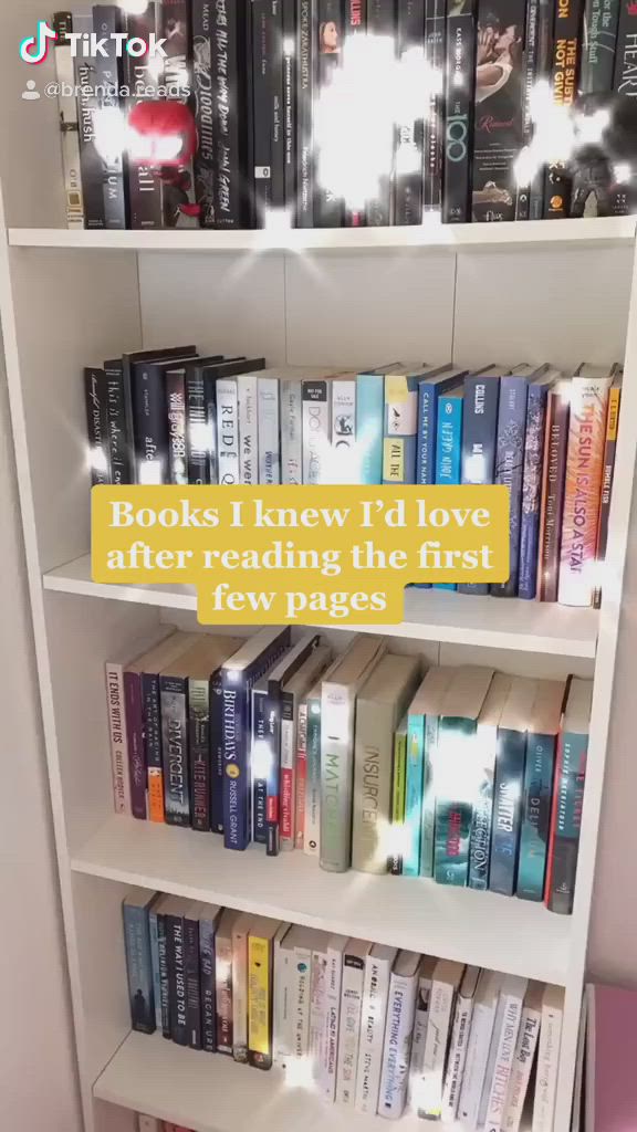 This may contain: a book shelf filled with lots of books next to a wall mounted light that reads books i knew i'd love after reading the first few pages