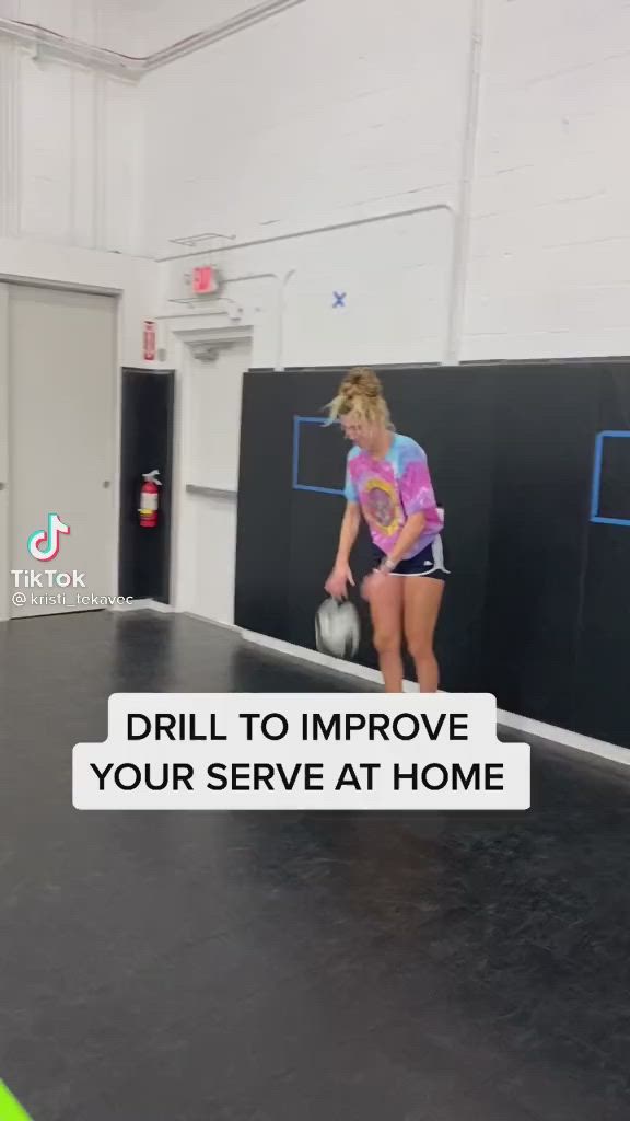 This may contain: a girl is playing with a ball in an indoor bowling court that has the words drill to improve your serve at home