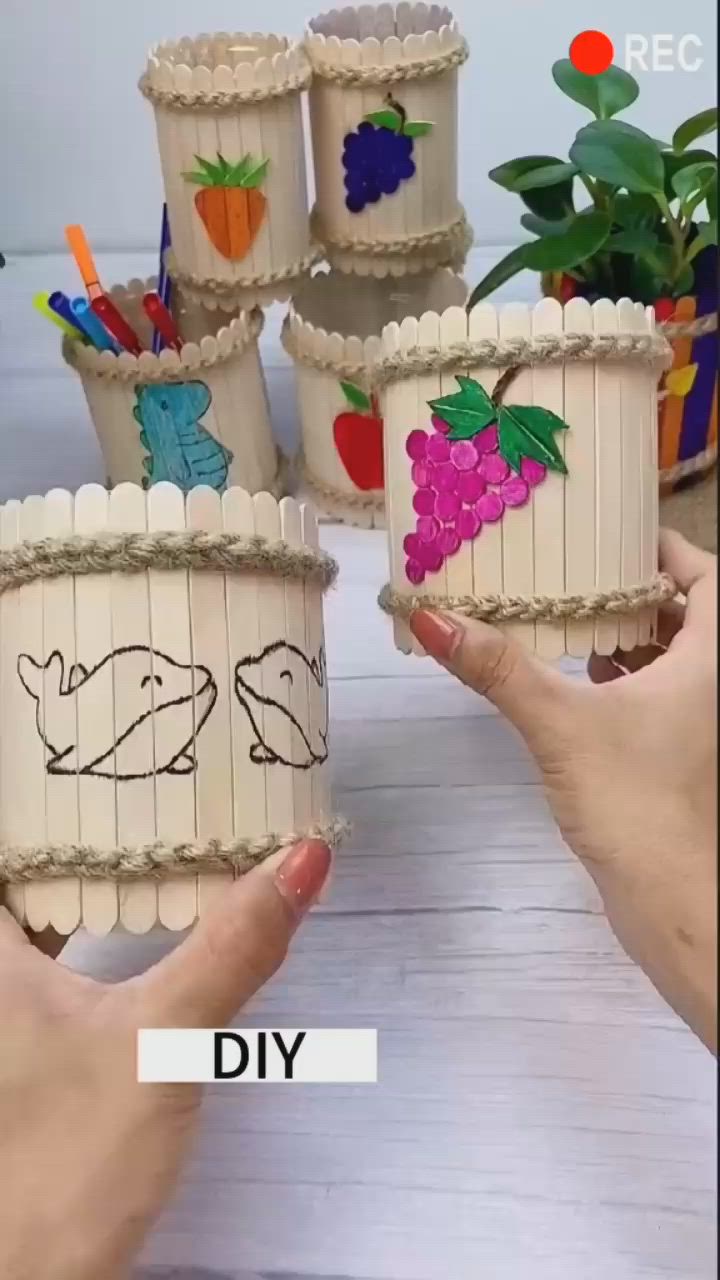 This may contain: two hands are holding small cupcakes made to look like toothpicks