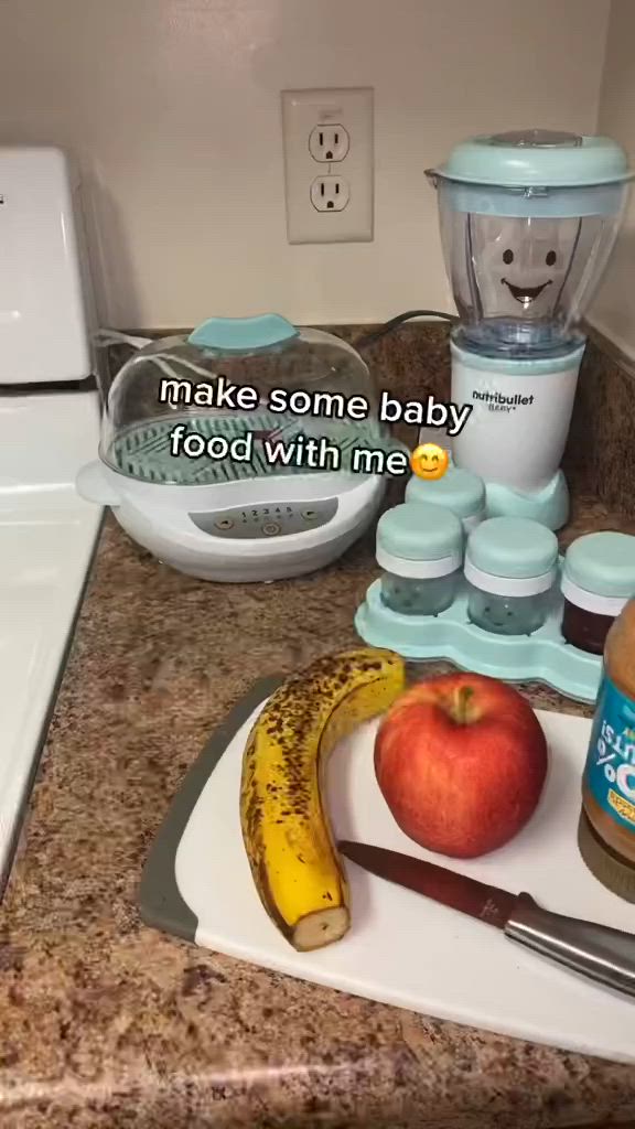 This may contain: a baby food processor, blender, and fruit on a counter top with the words make some baby food with me