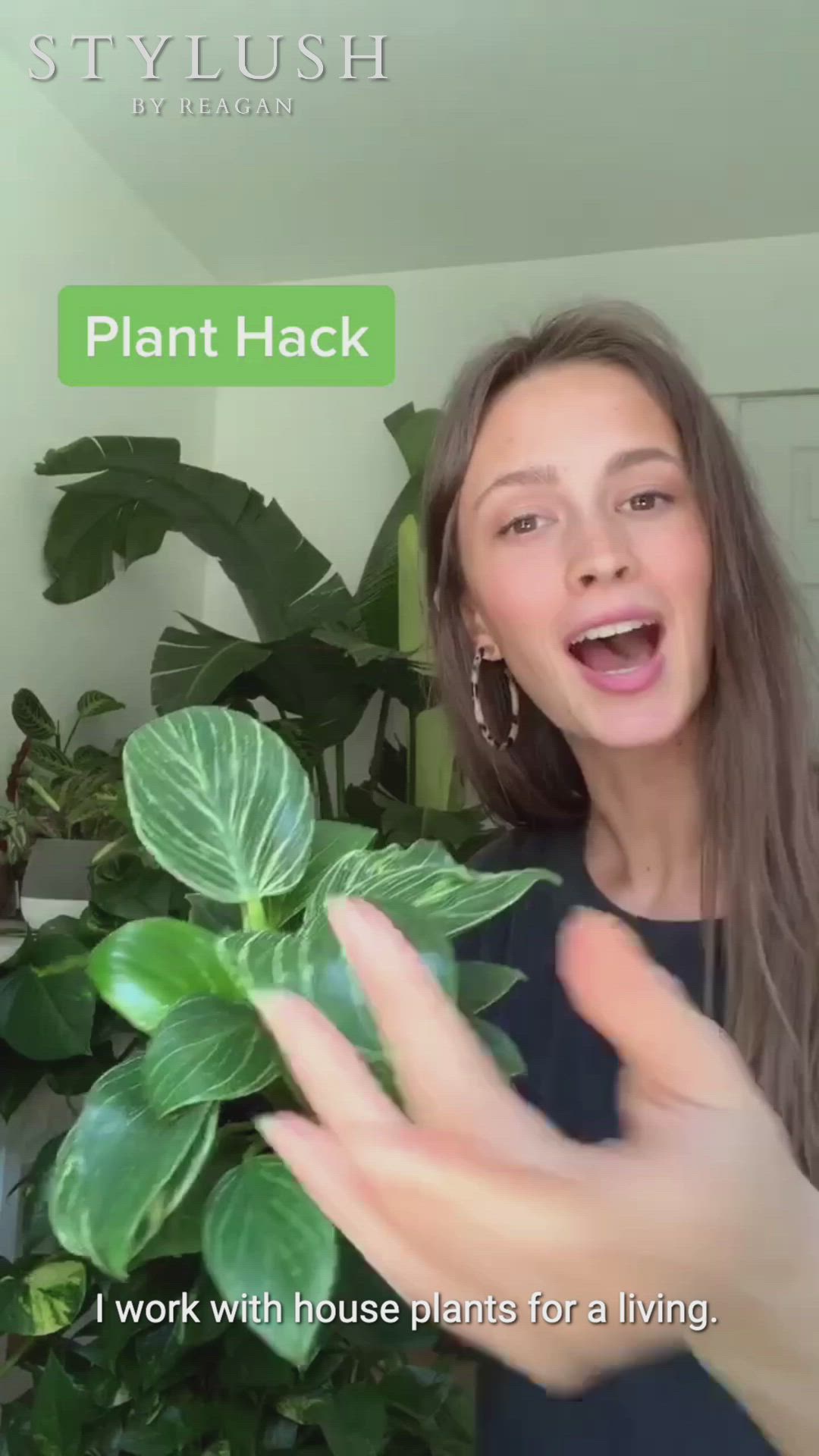This may contain: a woman is holding up a plant in front of her face with the words plant hack written on it