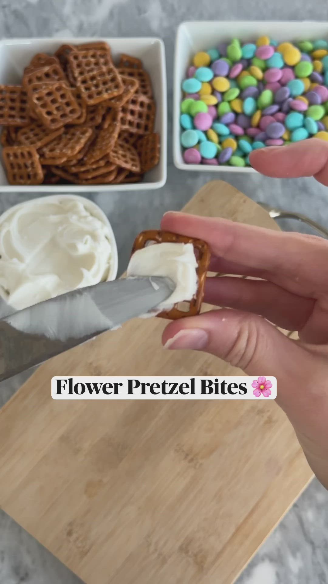 This may contain: a person holding a knife over some food on a cutting board with the words flower pretzel bites in front of them