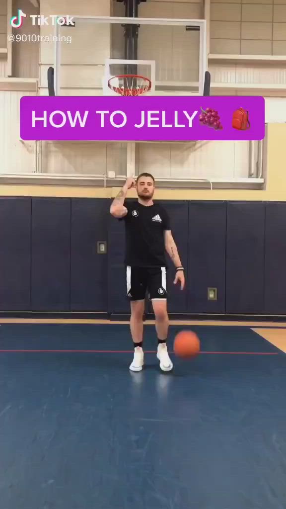 This may contain: a man standing on top of a basketball court with a ball in front of him