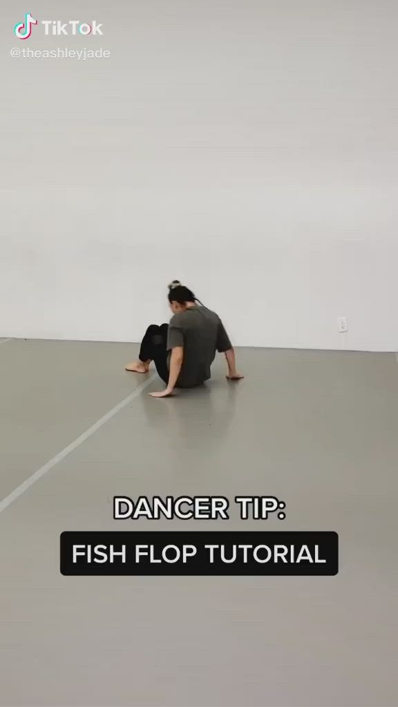 This may contain: a person sitting on the floor with their feet up in front of them and text that reads, dancer tip fish flop tutor