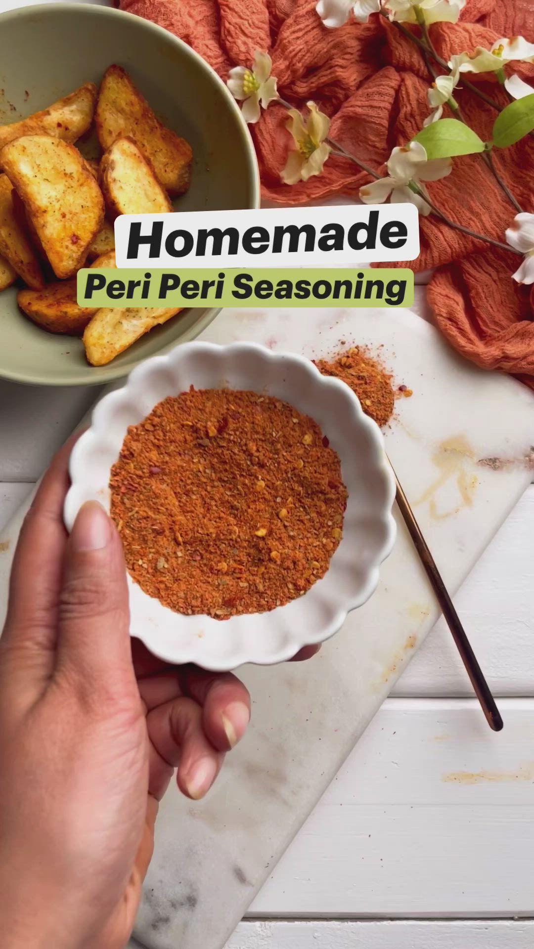 This may contain: someone is holding a bowl with some food in it and the words homemade peri peri seasoning