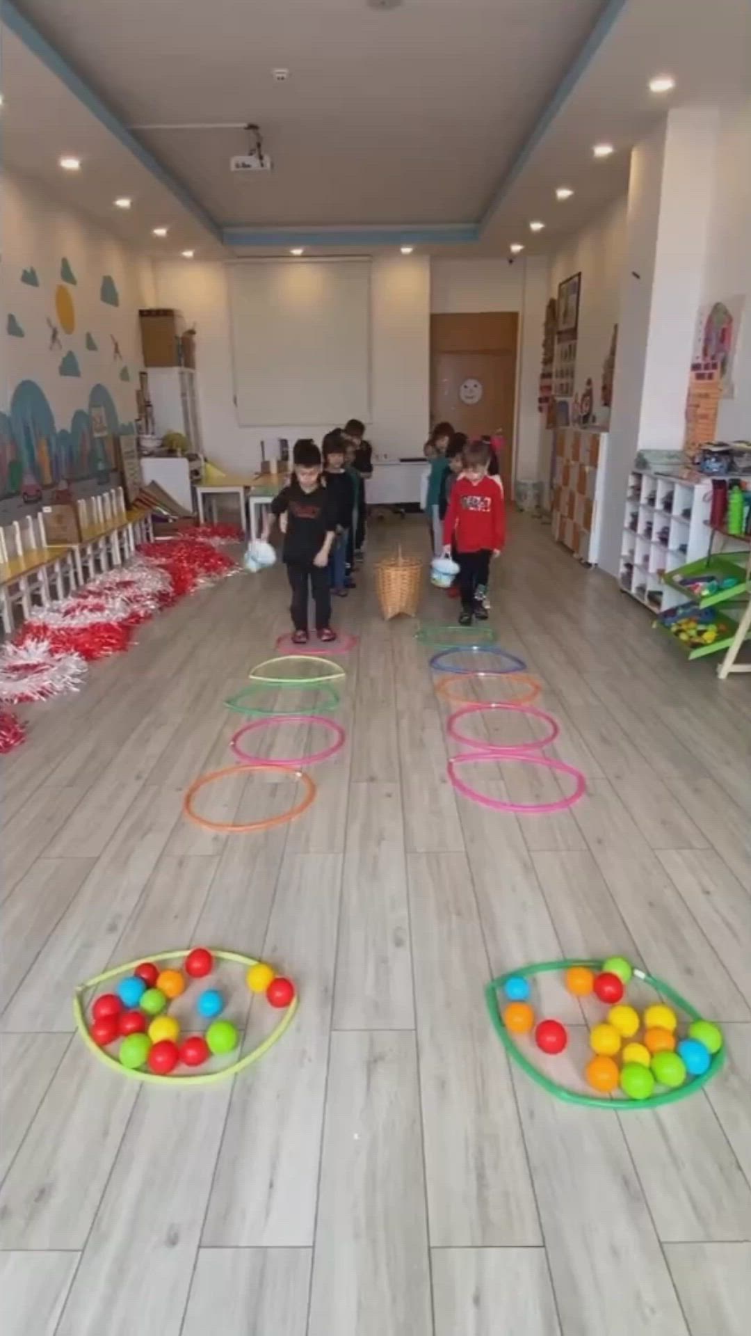 This may contain: children are playing with their toys on the floor in an indoor area that looks like a school