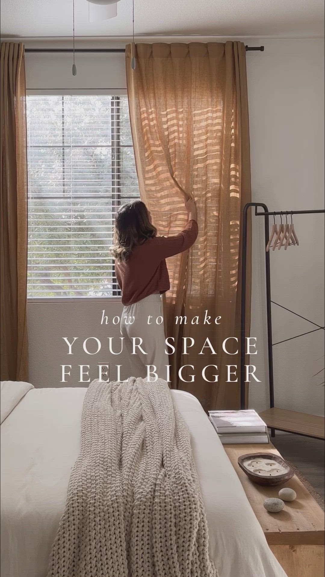 This may contain: a woman standing in front of a window with the words how to make your space feel bigger