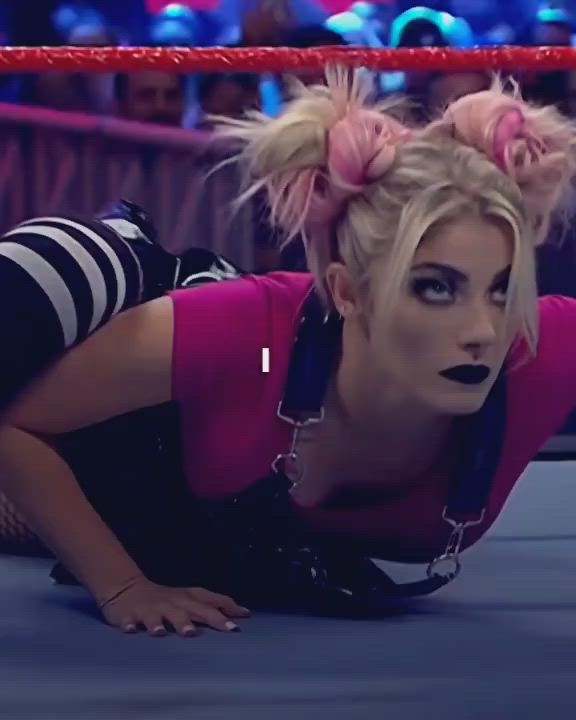 This may contain: a woman laying on the ground in front of a wrestling ring wearing black and pink makeup