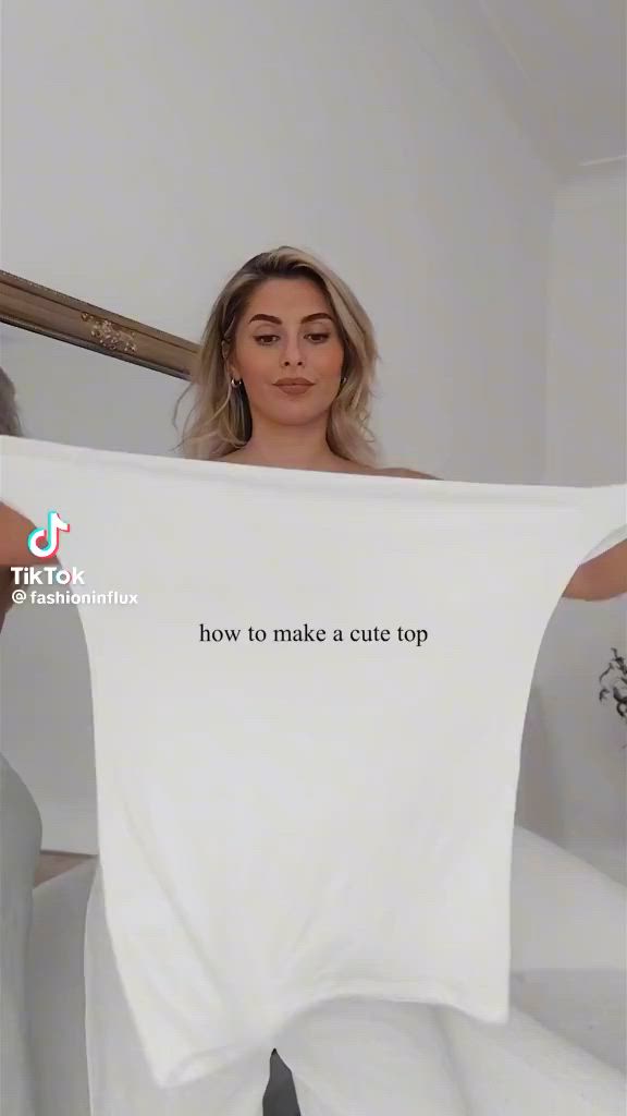 This may contain: a woman holding up a t - shirt that says how to make a cute top