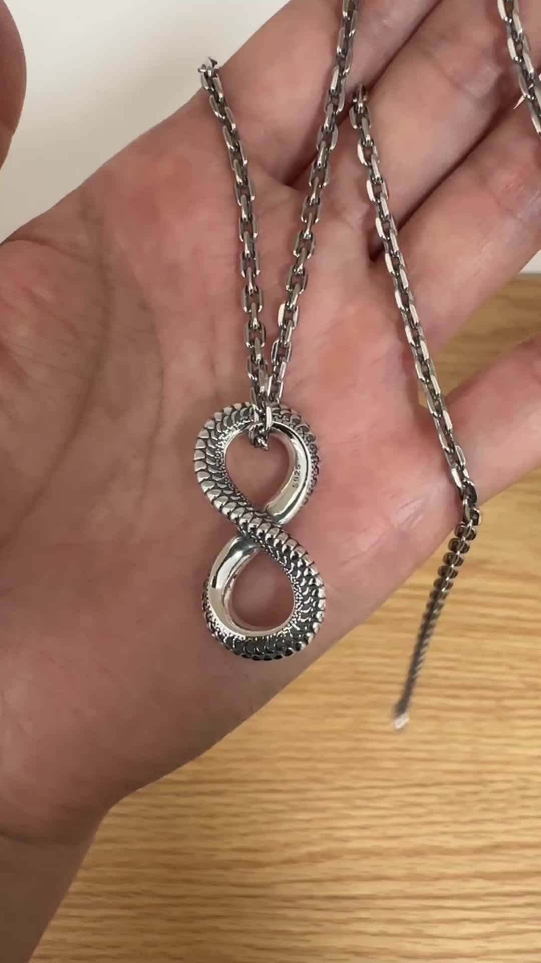 This contains an image of: Men's Sterling Silver Infinity Pendant Necklace