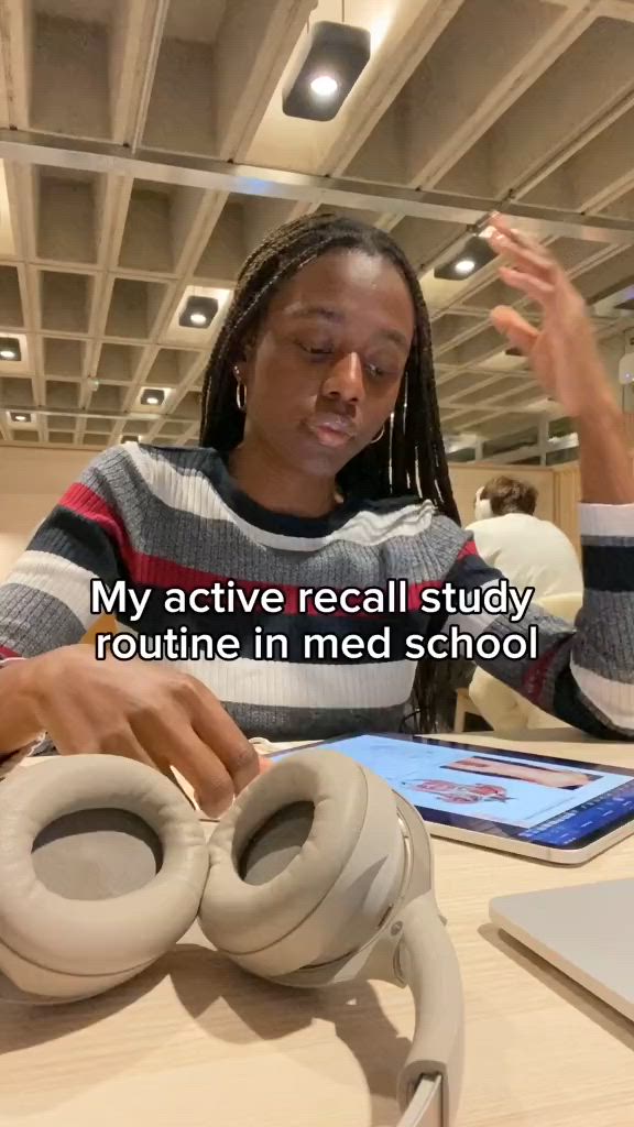 This may contain: a woman sitting at a table with headphones in front of her and text that reads, my active recall study routine in med school