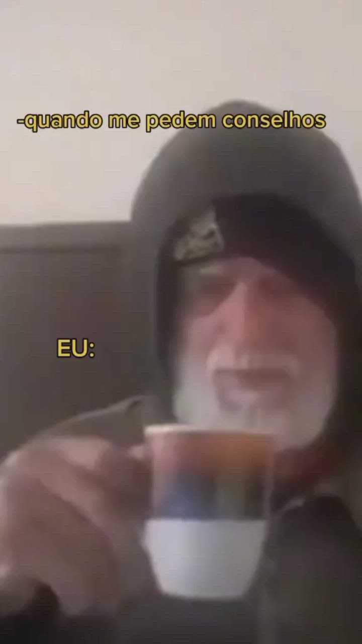This may contain: an old man is drinking from a cup