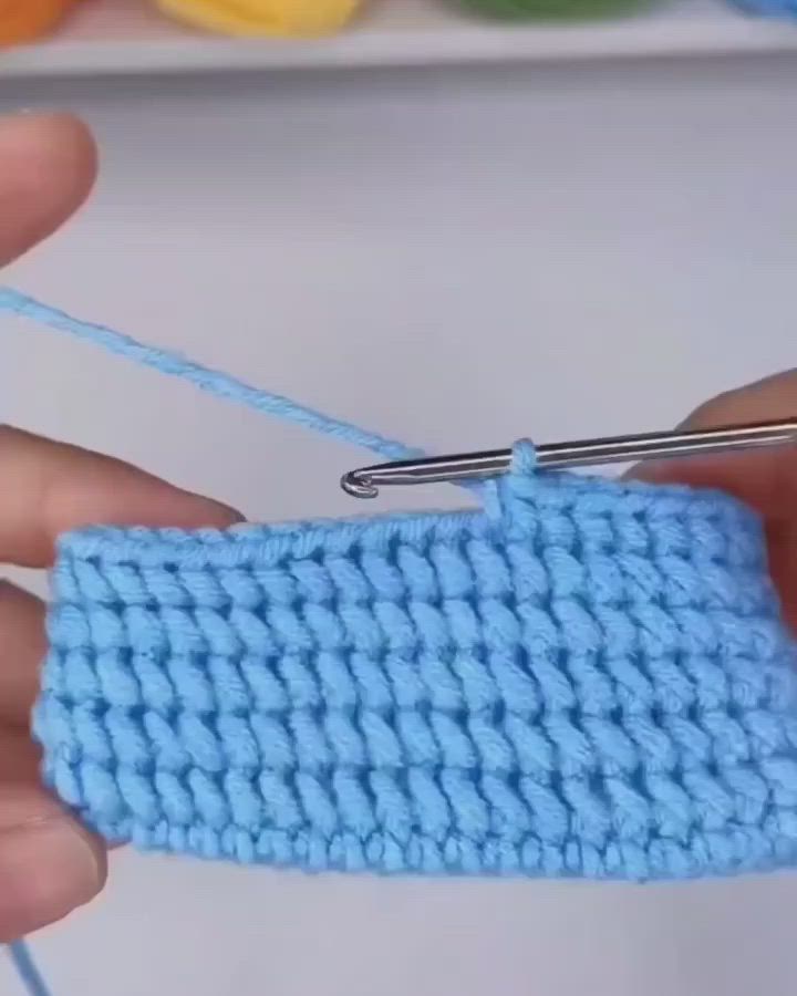 This may contain: someone is crocheting the stitchs together