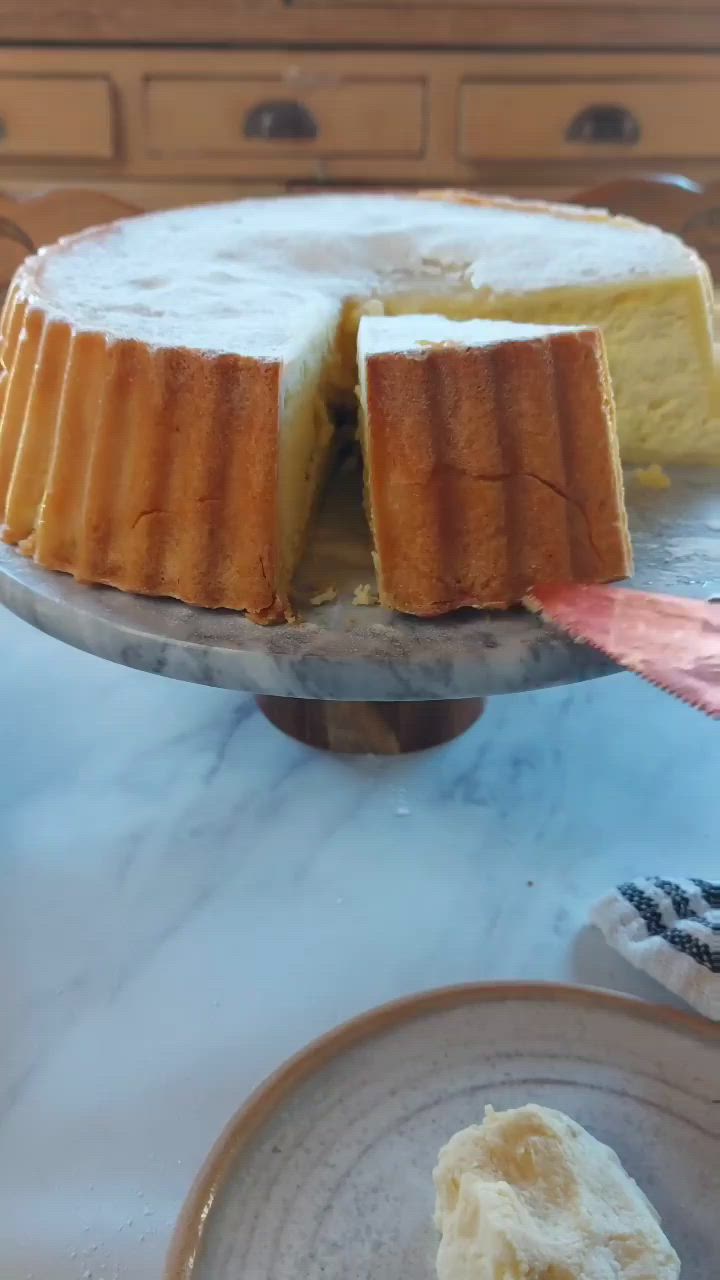 This may contain: a cake with one slice missing from it on a plate next to another piece of cake