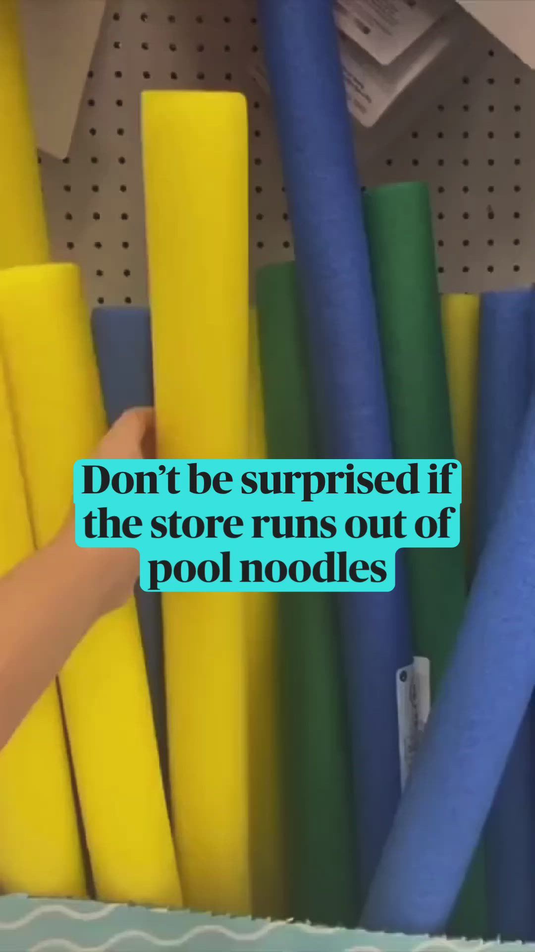 This may contain: a person is reaching for some blue and yellow pool noodles in a bin with the words don't be surprised if the store runs out of pool noodles