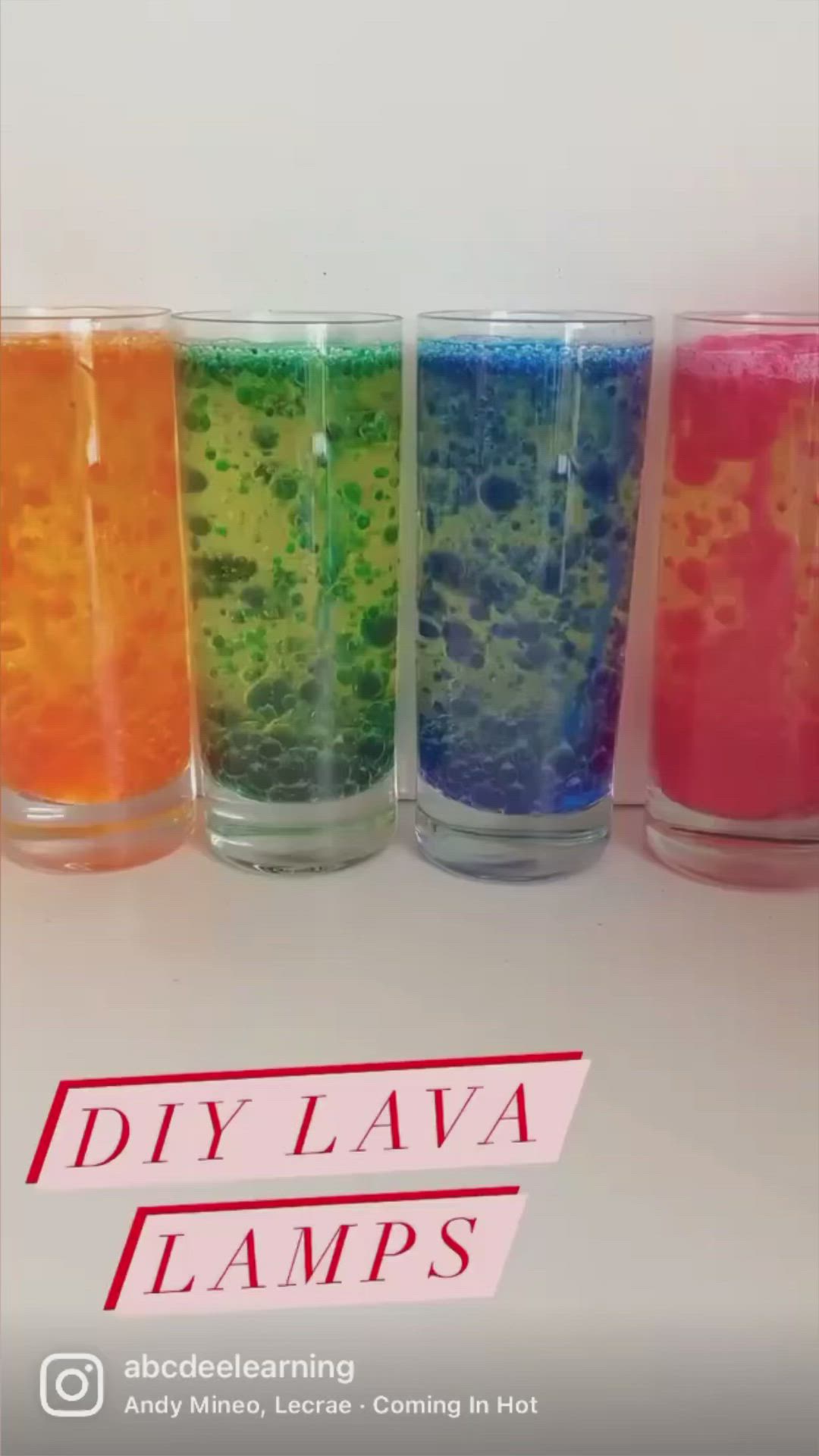 This may contain: four glasses filled with different colored liquids on top of a white table and the words diy lava lamps above them