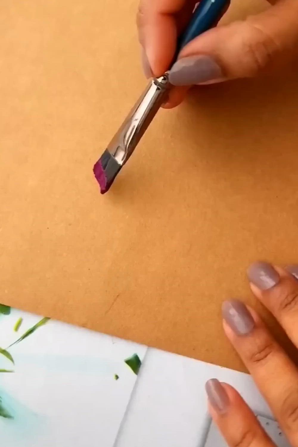 This may contain: a woman is painting flowers on a piece of paper