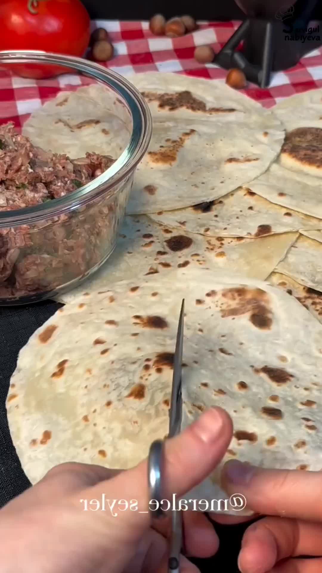 This may contain: someone is cutting up some tortillas with a knife