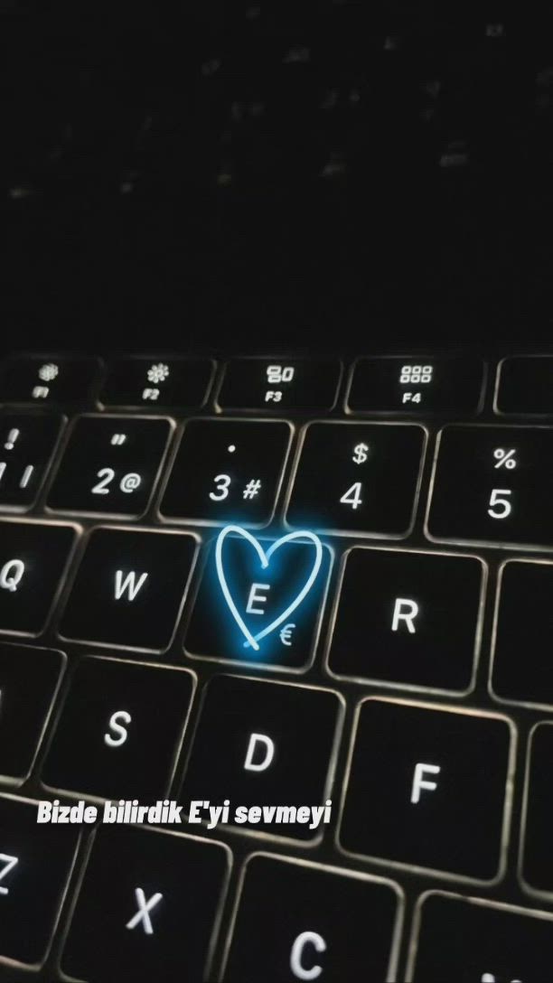 This may contain: a blue heart is on the keyboard of a black laptop that says, i love you