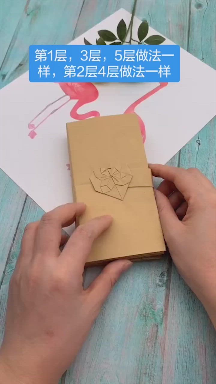 This may contain: someone is cutting out a card with scissors and glue on the paper that has been placed in front of an envelope