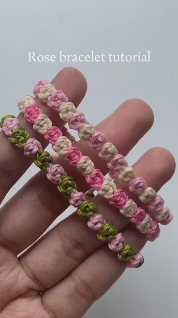 This may contain: someone is holding two small crocheted bracelets in their left hand and the third has been made from yarn