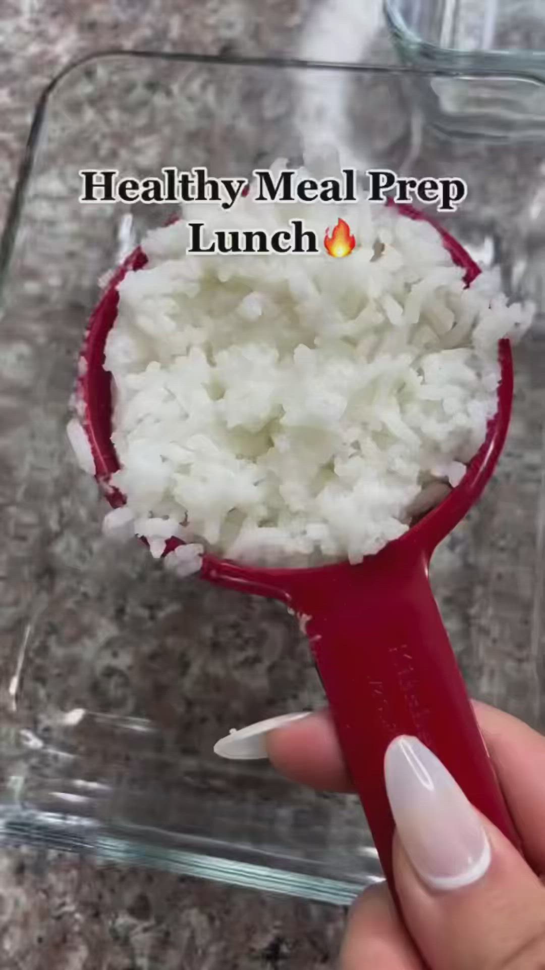 This may contain: a person holding a spoon with rice in it