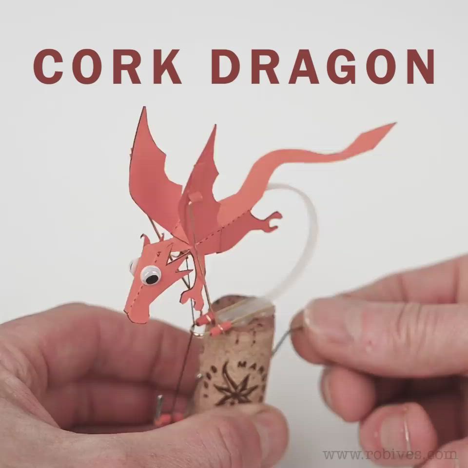 This may contain: two hands are holding corks and making a dragon