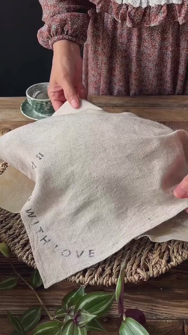 This may contain: someone is making something out of an old linen bag with the words make love written on it