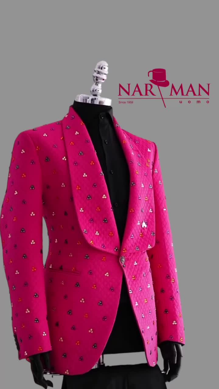 This may contain: a mannequin wearing a pink suit and black shirt