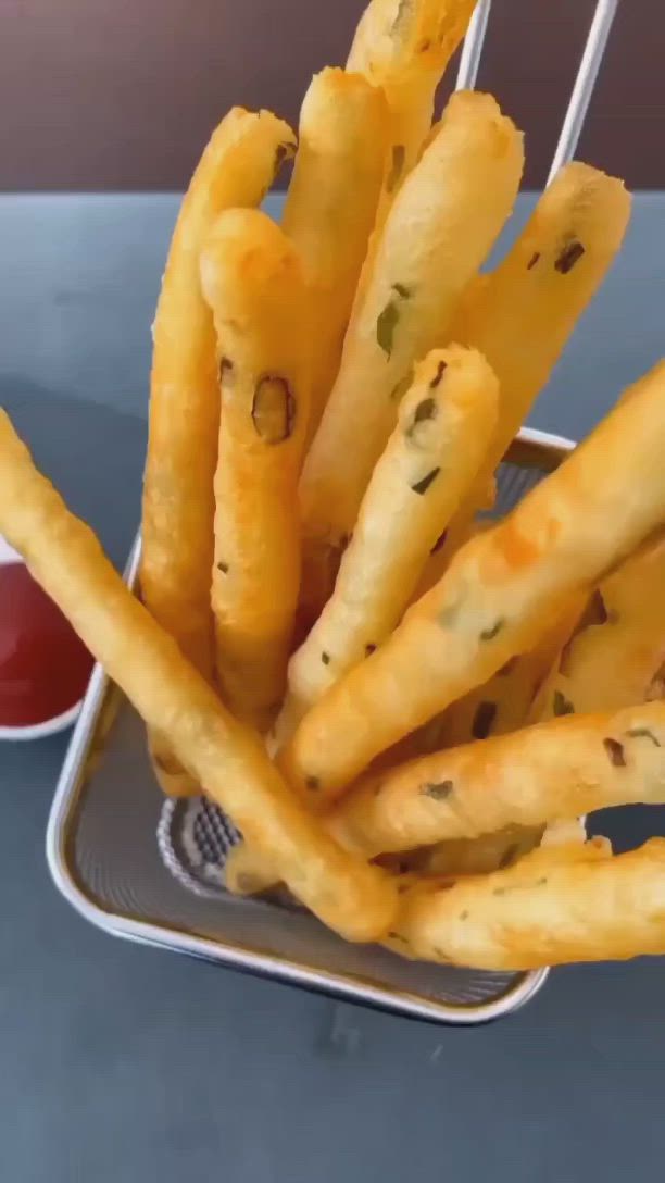 This may contain: a basket filled with french fries next to ketchup