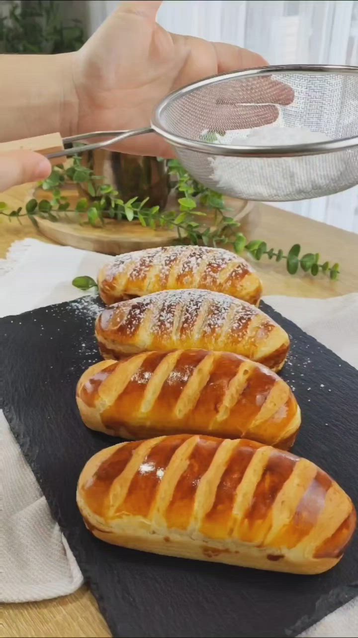 This may contain: four hotdogs on a black plate being held by a person's hand