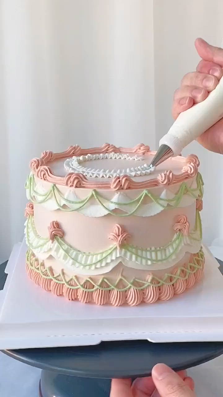 This may contain: a person is cutting into a cake with pink icing