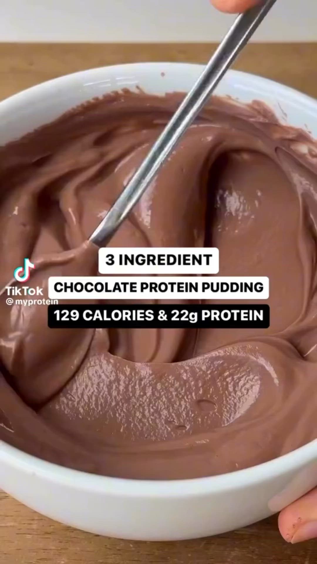 This may contain: someone is holding a spoon over a bowl of chocolate protein pudding with the text 3 ingredient chocolate protein pudding