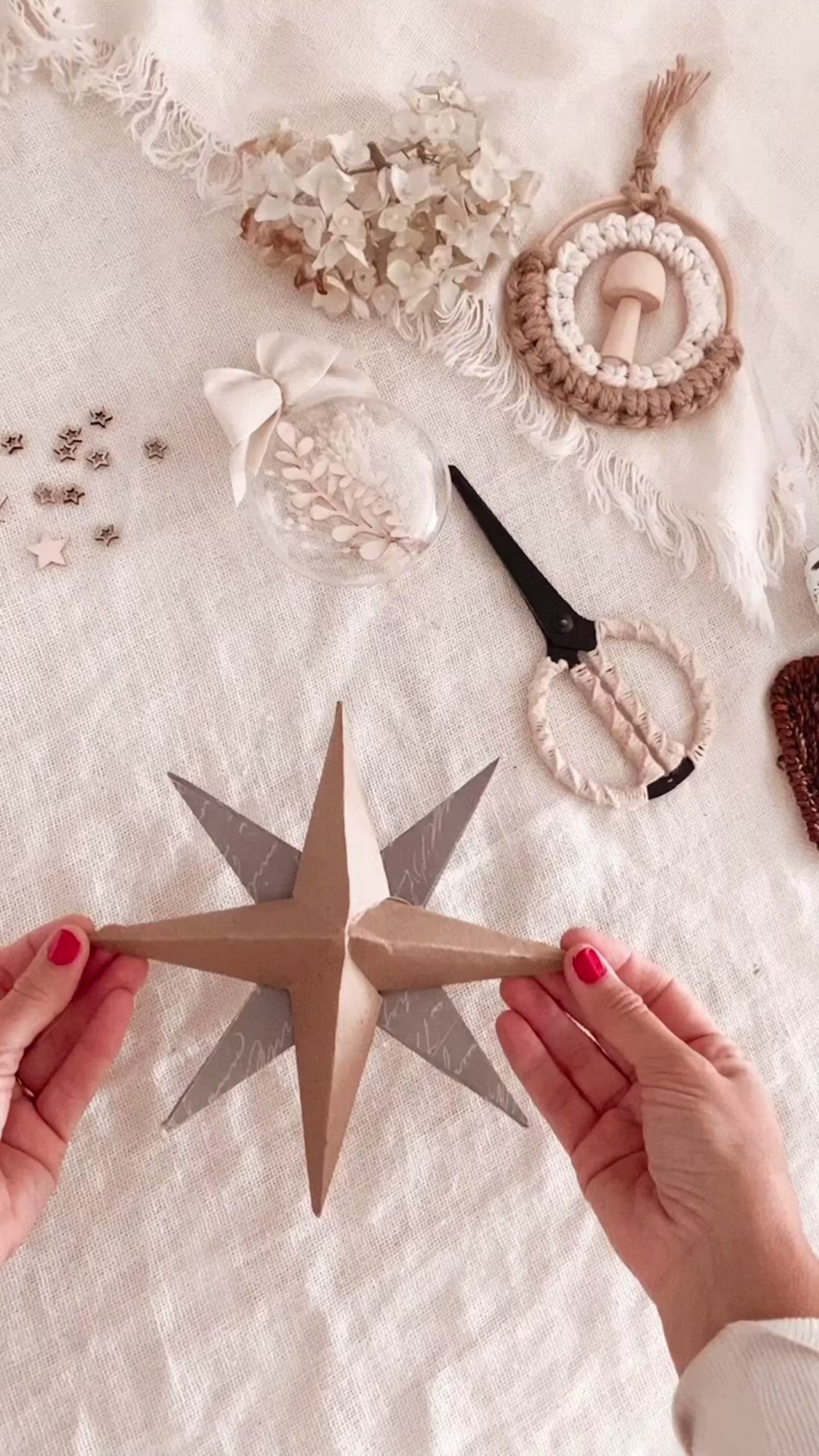 This may contain: a white christmas decoration with stars and deers on the table next to pine cones