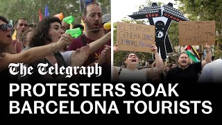 video: Watch: Anti-tourism protesters fire water guns at diners in Barcelona