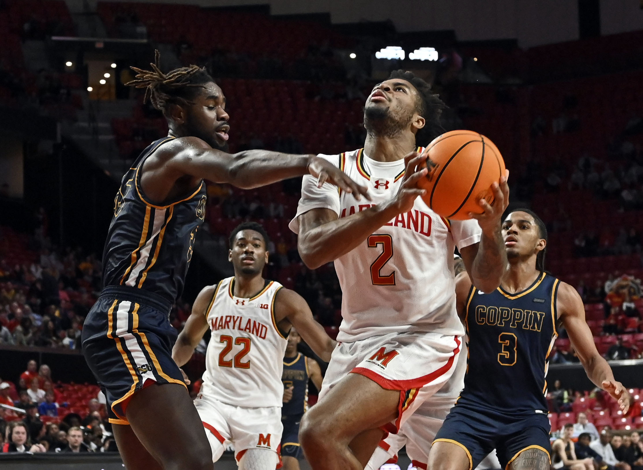 Marylandxe2x80x99s Jahari Long, right, goes to the basket against Coppin Statexe2x80x99s Justin Winston, left, in the second half. Maryland defeated Coppin State 75-53 at Xfinity Center. (Kenneth K. Lam/Staff photo)