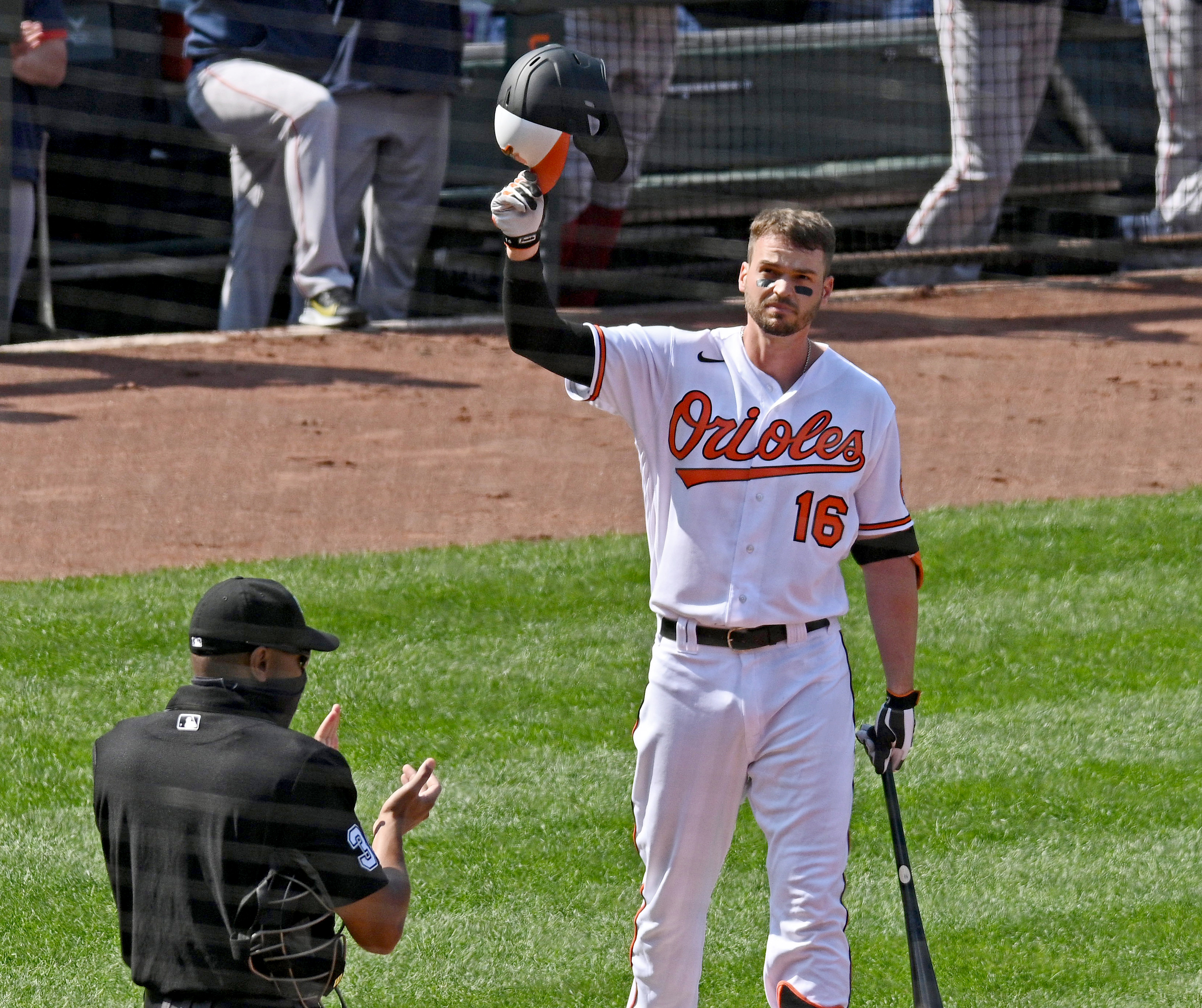 Orioles' Trey Mancini tips his helmut to fans' ovation as he comes up to bat against the Red Sox for the first time in the first inning of the O's 2021 season home opener at Oriole Park at Camden Yards on April 8, 2021.