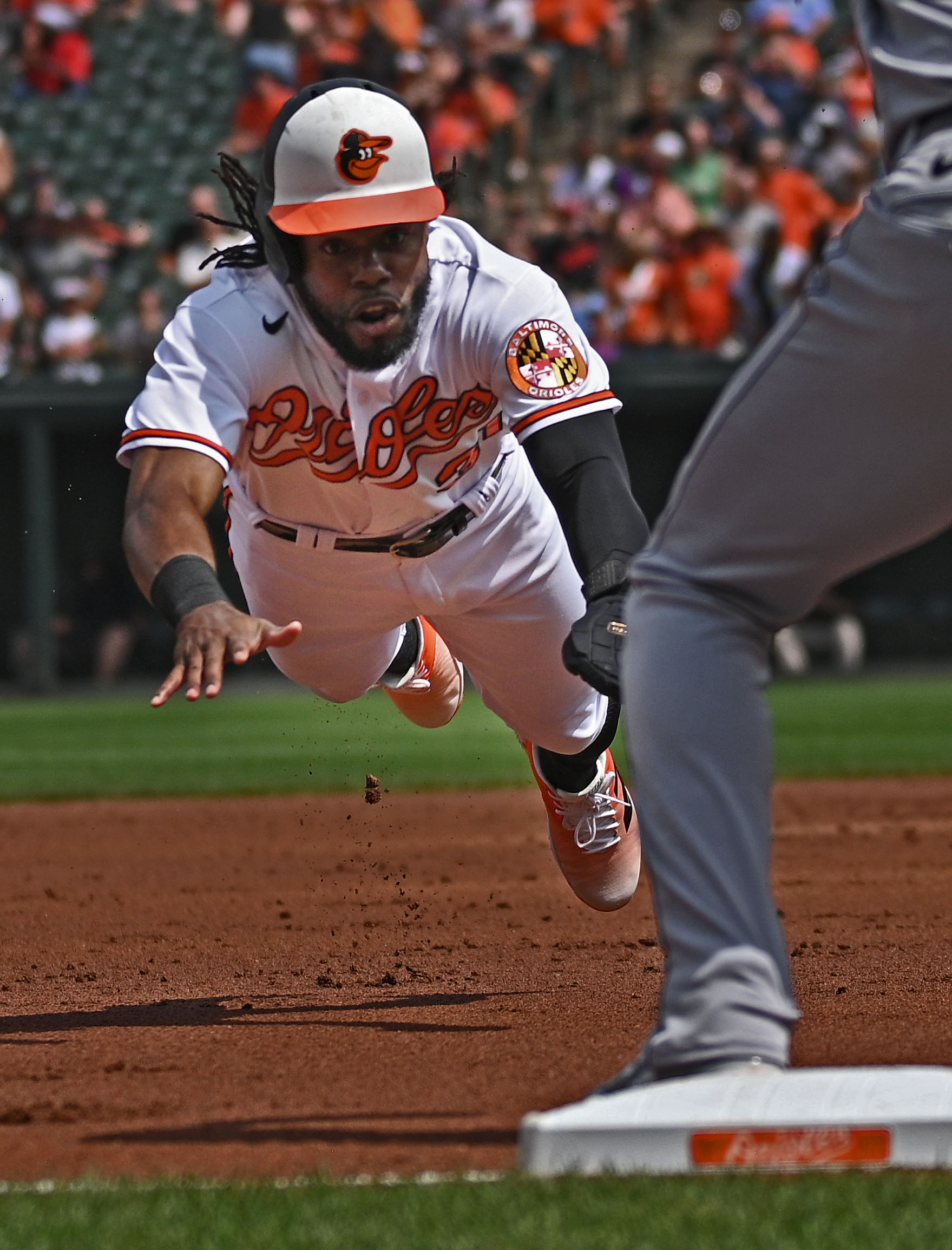 Orioles' Cedric Mullins dives into third base and later scores against the White Sox in the first inning at Oriole Park at Camden Yards.Aug. 30, 2023 Kenneth K. Lam