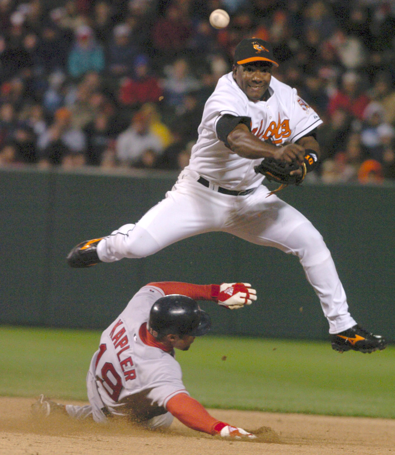 BALTIMORE , MD -- 4/4/04 - The Baltimore Orioles host the Boston Red Sox in their Opening Day game. Miquel Tejada turns a double play in the top of the 6th inning throwing out Jason Varitek as Boston's Gabe Kapler slides underneath him.Baltimore Sun Staff/ELIZABETH MALBY DIGITAL IMAGE #DSC_0005