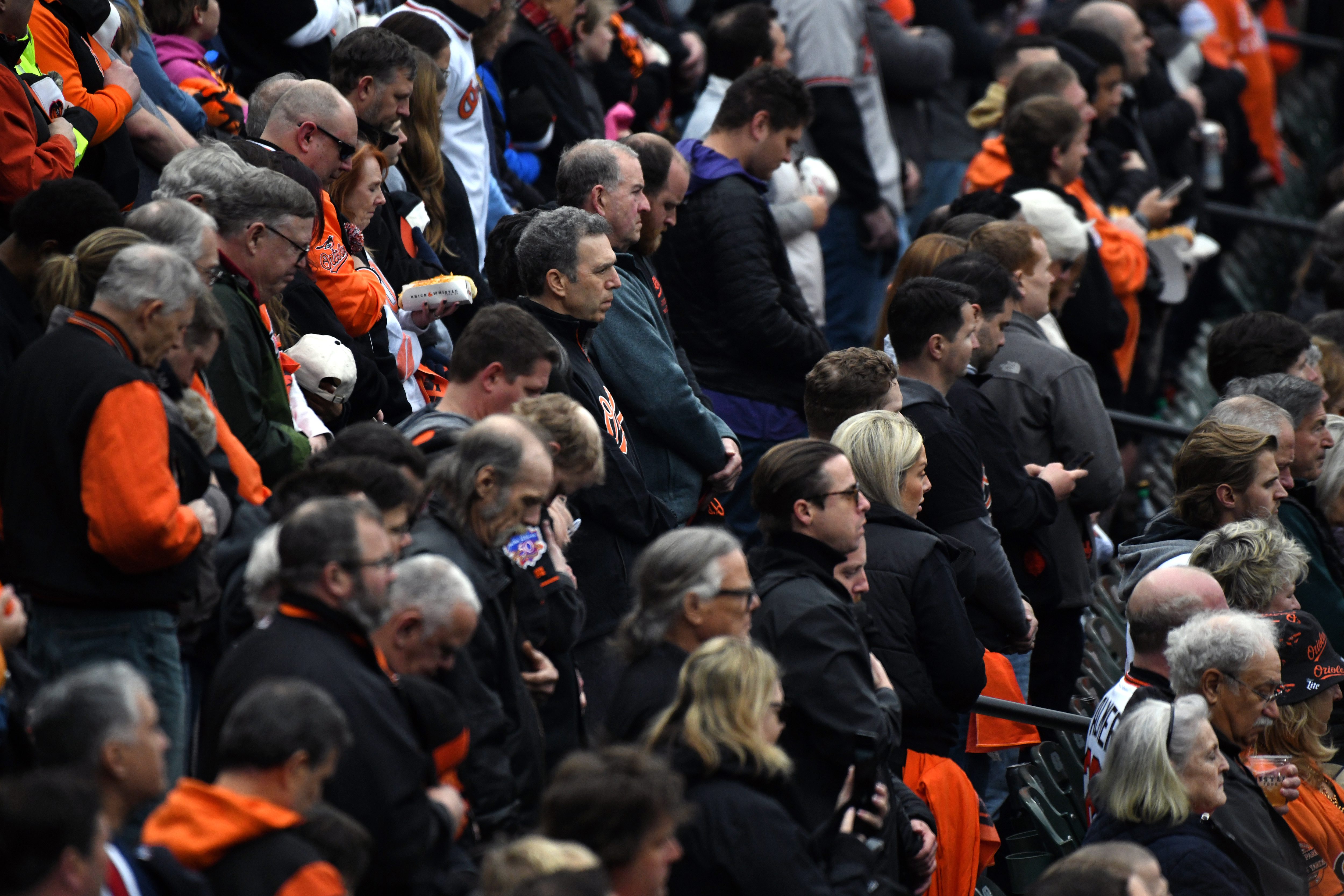 Mar. 28, 2024: Fans observe a moment of silence for victims of the Francis Scott Key Bridge collapse during the opening day ceremony. The Baltimore Orioles host the Los Angeles Angels at Oriole Park at Camden Yards. (Kim Hairston/Staff)